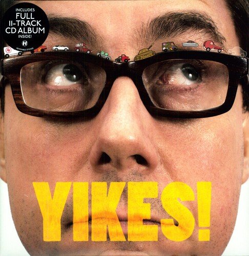 A man's face wearing black glasses with toy cars on top, with "YIKES!" below.