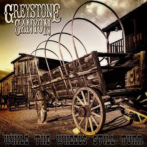 "Album cover featuring an old, broken wooden wagon in front of a barn."