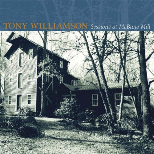 "Album cover with a black-and-white image of a large, old wooden house surrounded by trees."