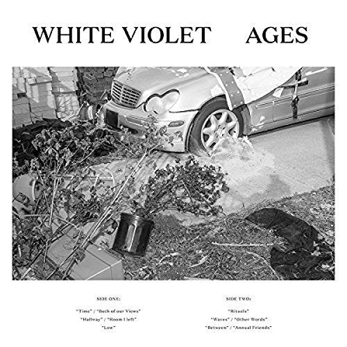 A vinyl record album cover featuring a black-and-white image of a crashed car.