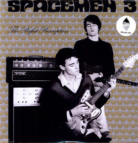 "Vinyl record cover with two men and guitars, patterned background."