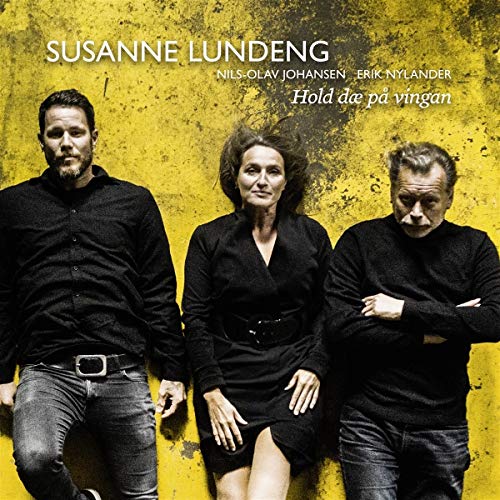 "CD cover featuring three musicians in black against a yellow grungy background."