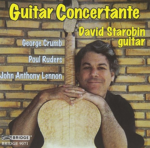 "CD cover featuring a man holding a guitar against a brick wall."