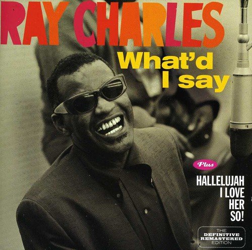 "Ray Charles smiling in a recording studio, wearing sunglasses, with band members behind him."