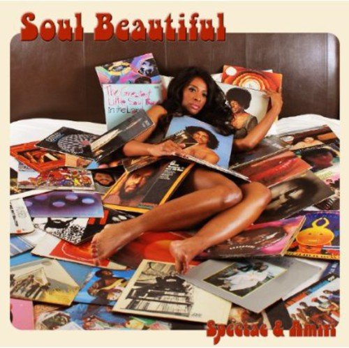 Album cover with a woman surrounded by vinyl records on a bed.