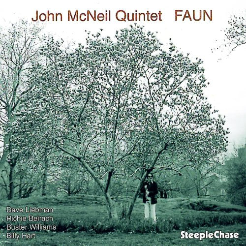 "Album cover with a man standing under a tree, in a forest."