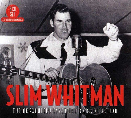 Black and white image of Slim Whitman holding a guitar and standing by a microphone.