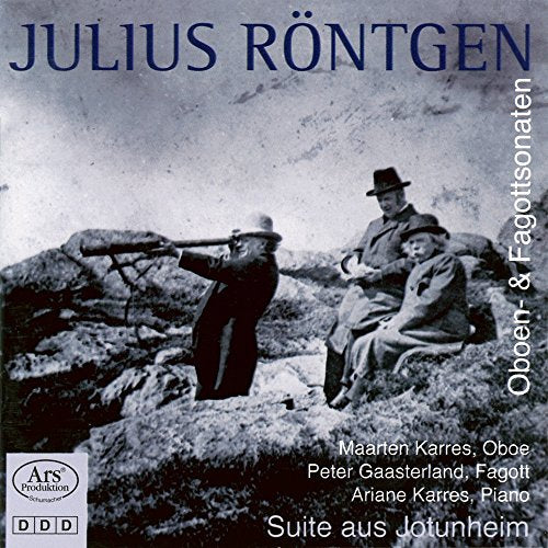 Black and white CD cover featuring three men sitting on a rocky hillside.