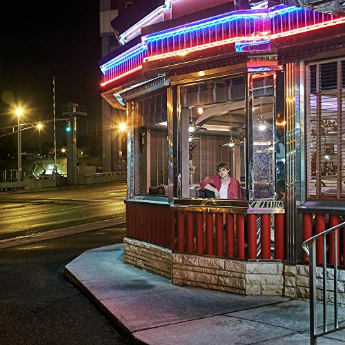The alt text for the image is: "A vinyl record with a neon diner scene cover."