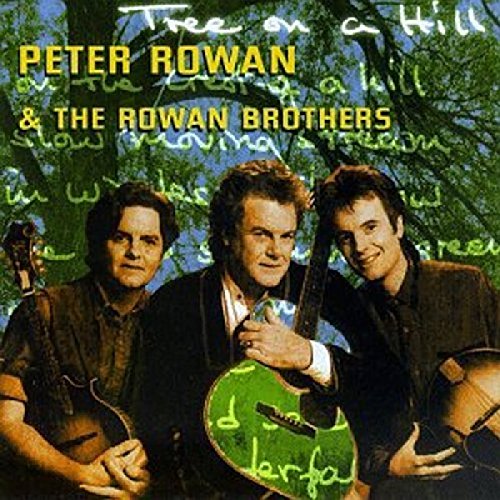 "Album cover featuring three men with guitars in front of a tree."