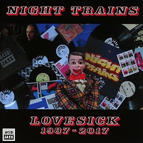 "Album cover with ventriloquist's dummy surrounded by vinyl records and promotional materials."