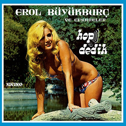"Album cover with a blonde woman in a bikini posing on a rock."