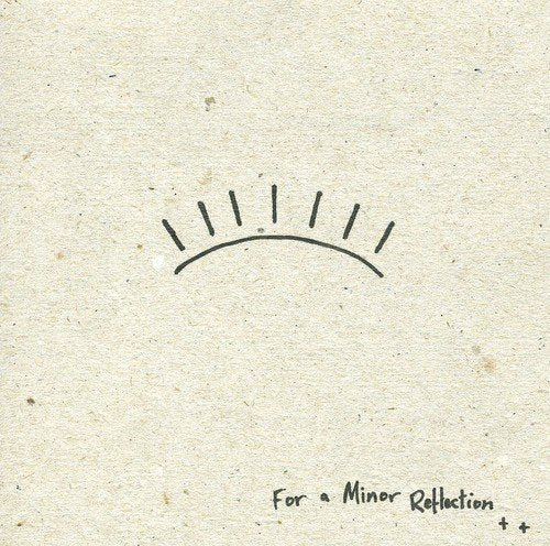 "Brown cardboard CD cover with simple black sun drawing and artist's name."