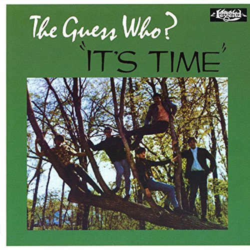 The image shows a green album cover with a photograph of three men in a tree.