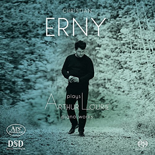 Man in black stands on a path, looking down, on a CD cover.