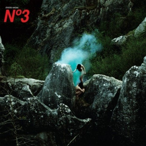 Vinyl album cover featuring a woman surrounded by smoke on rocky terrain.
