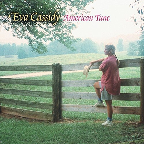 Vinyl album cover featuring a woman leaning on a wooden fence outdoors.