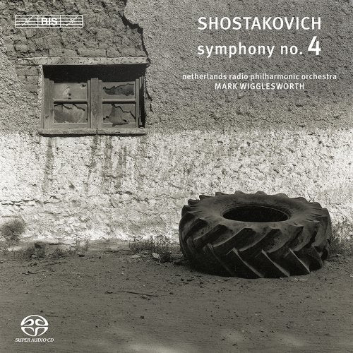 "CD cover with a tractor tire and a stone wall."
