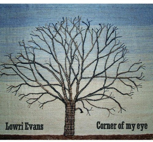 "Album cover featuring a bare tree with 'Lowri Evans' and 'Corner of my eye' text."