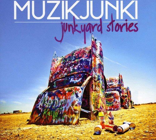 "CD cover art featuring a graffiti-covered Cadillac structure in a desert landscape."