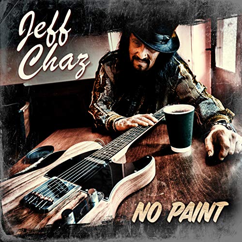 "Album cover with man in hat holding guitar and coffee cup on a table."