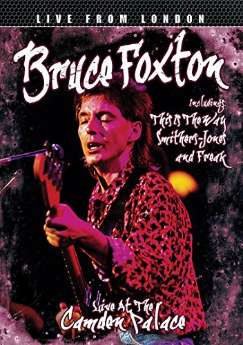 "Bruce Foxton playing guitar on stage, wearing a leopard print shirt, on DVD cover."