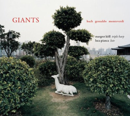 "Album cover with a white goat in a garden, surrounded by trimmed bushes and trees."