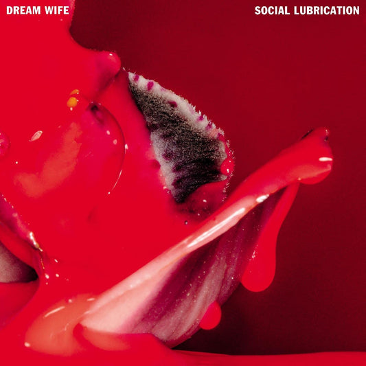 "Album cover with red background, close-up of lips with red liquid and white foam."
