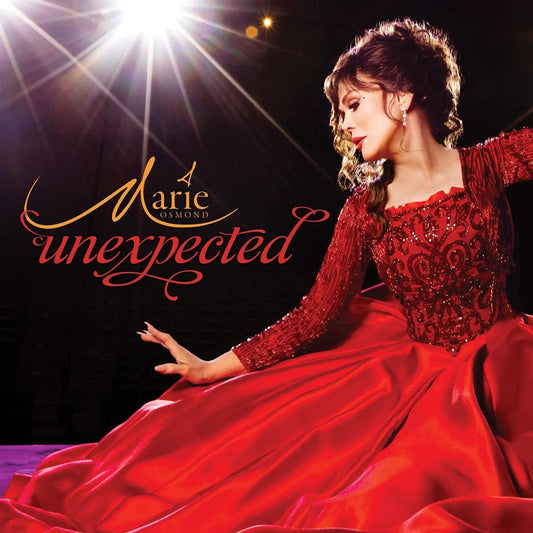"Marie Osmond album cover featuring a woman in a red dress under stage lights."
