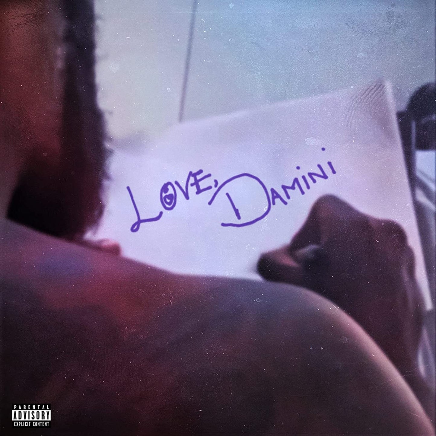 Burna Boy's album cover featuring a man holding a note that reads "Love, Damini".