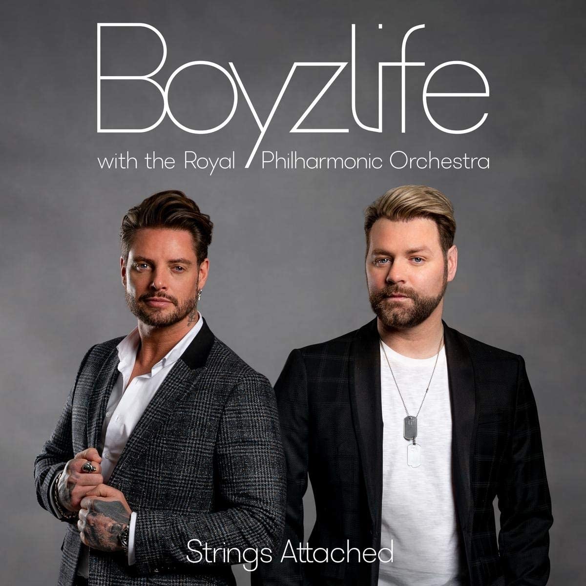 "Album cover featuring two men in suits against a gray background."