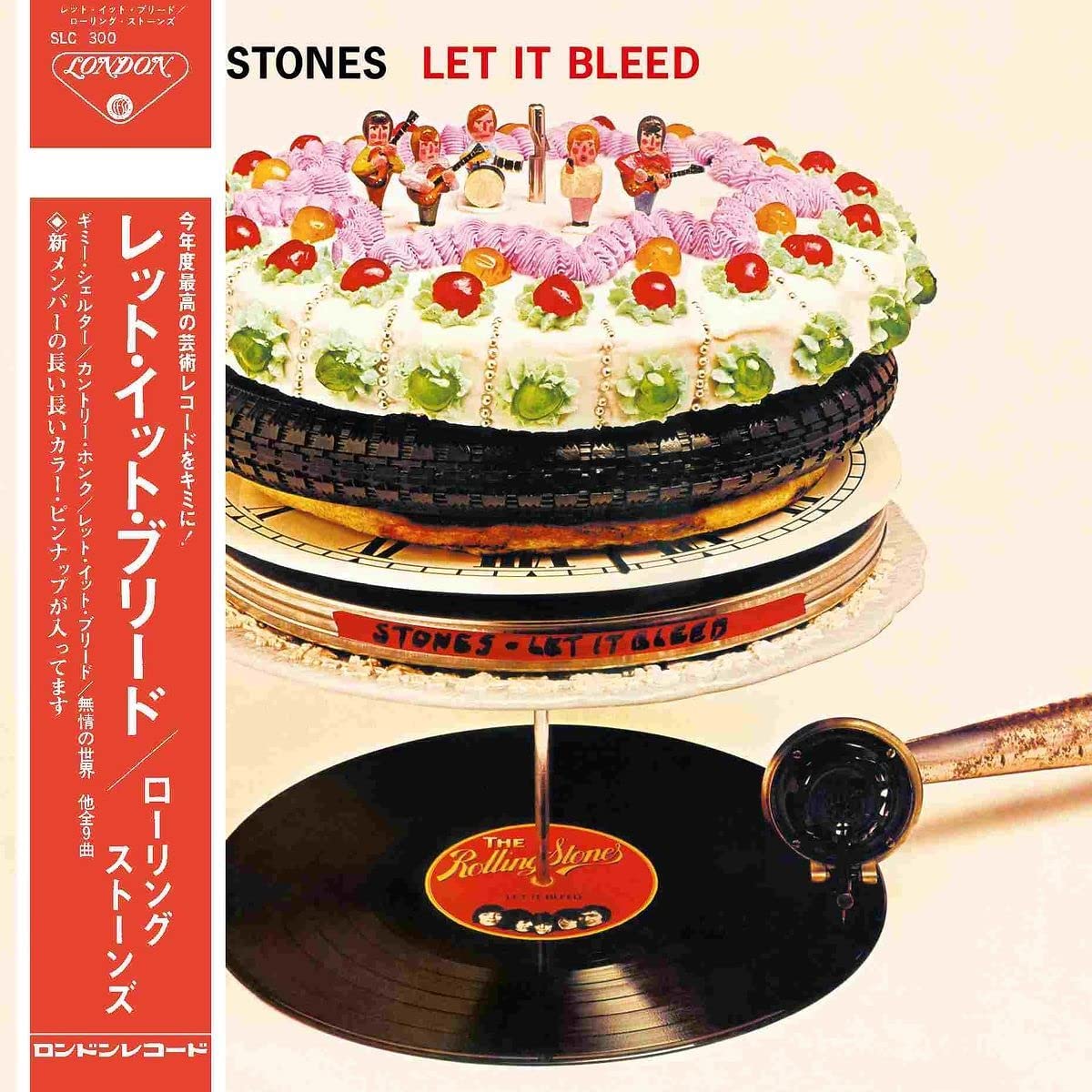 The image shows the Rolling Stones' "Let It Bleed" album cover, featuring a multi-layered cake resembling stacked vinyl records, with a gramophone playing a record below.