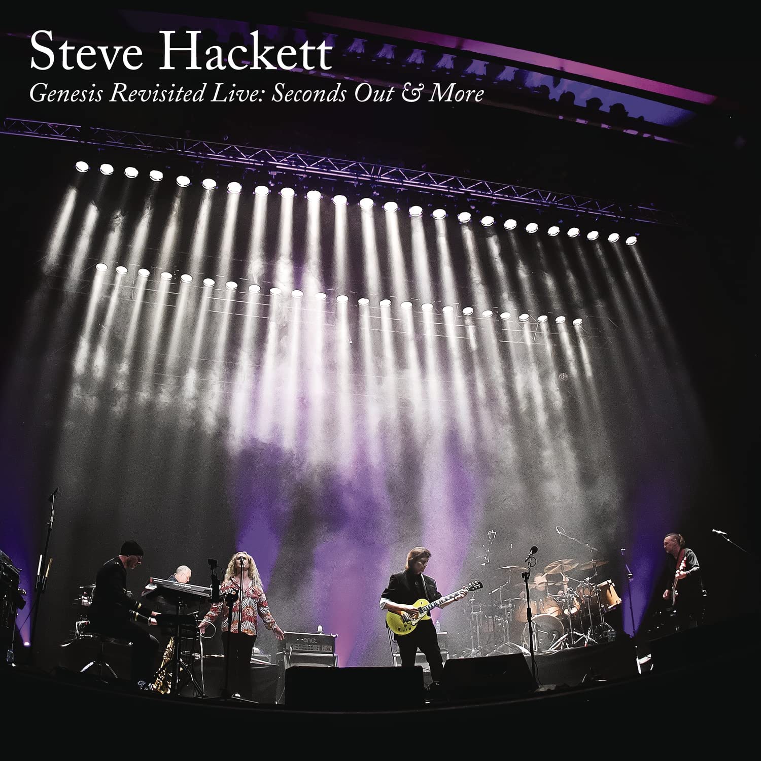 "Album cover featuring a band performing on stage under bright stage lights."