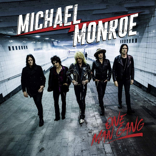 "Album cover with five men in black walking in a subway tunnel."