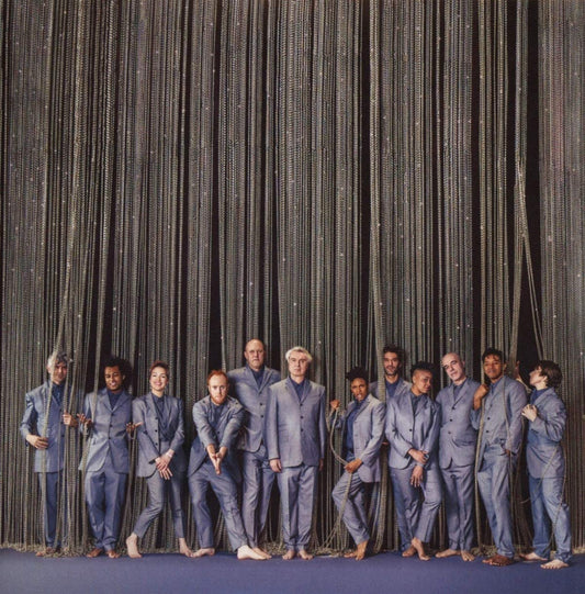 "CD cover art for 'American Utopia' featuring 11 men in gray suits standing together."