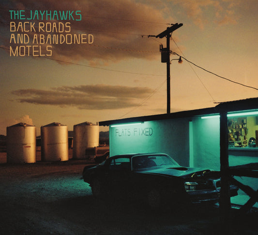 "Album cover: 'Back Roads and Abandoned Motels' by The Jayhawks, featuring a motel scene."