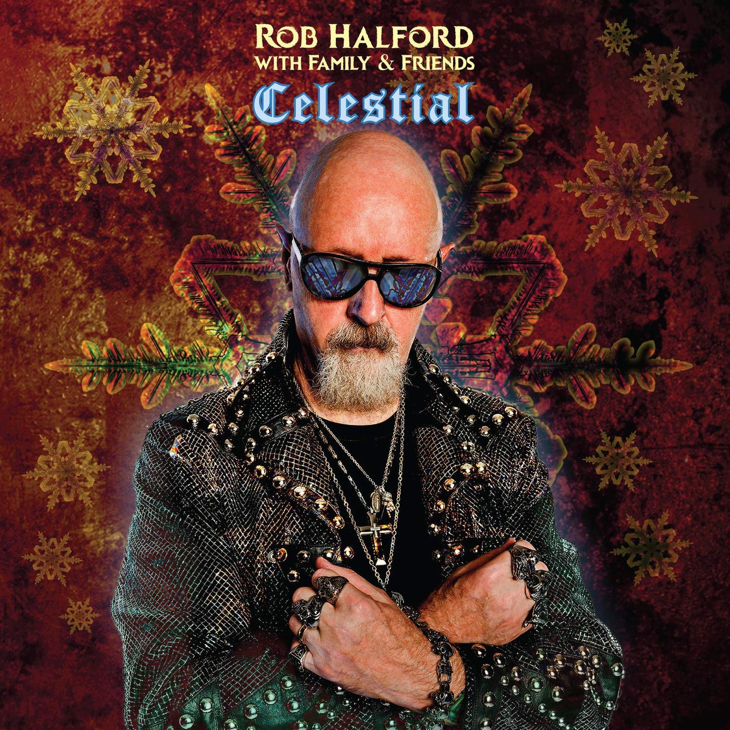 "Album cover featuring Rob Halford in a studded jacket against a red, snowflake-patterned background."
