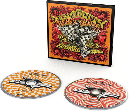 "CD case with orange cover and two discs, orange and white, on white background."